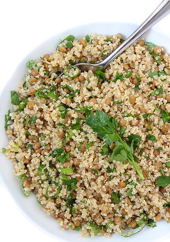 Gluten-Free Lentil Quinoa Salad - A vibrant and nutritious salad made with quinoa, lentils, bell pepper, cucumber, cherry tomatoes, red onion, parsley, mint, and sunflower seeds.